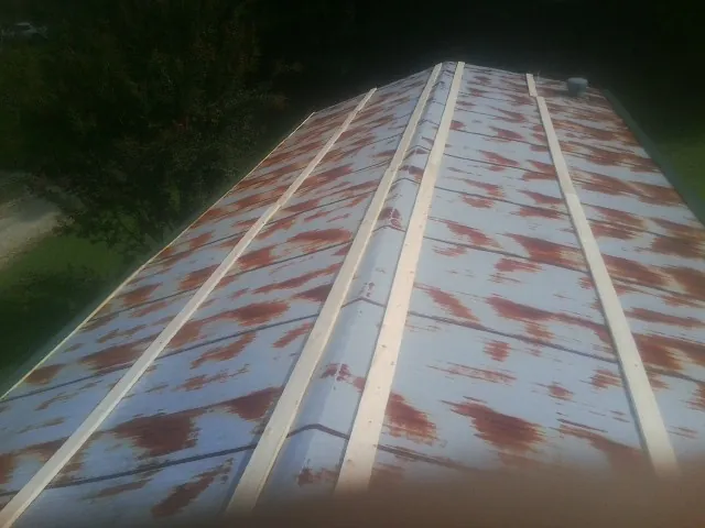 Rusted metal roof panels with new wood purlins before replacement — Storm Damage Roof Repair in Kannapolis by Roofing Brothers
