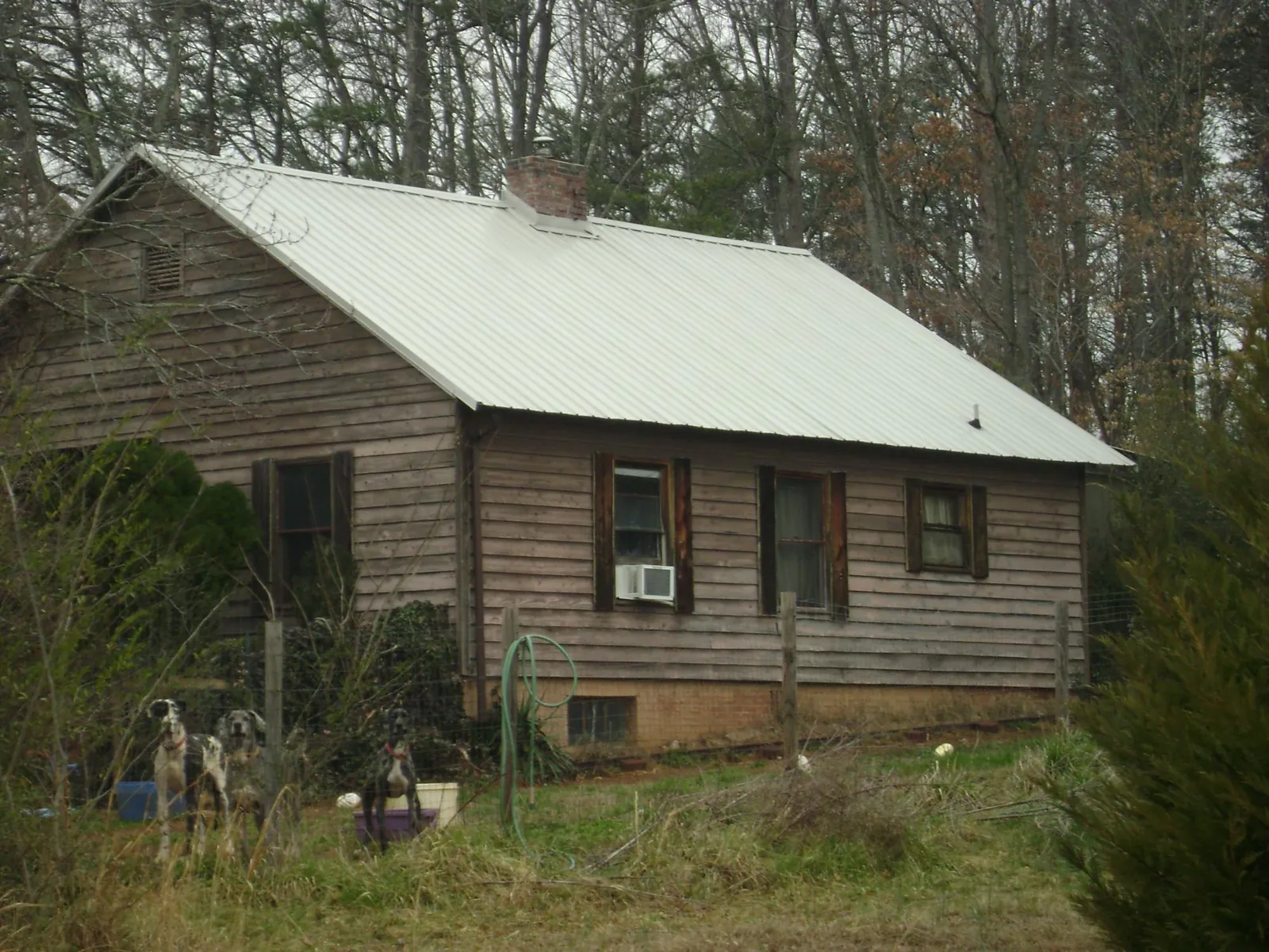 White metal roof on an old wood sided farmhouse, from a Asphalt Shingle Roof Repair job in Kannapolis
